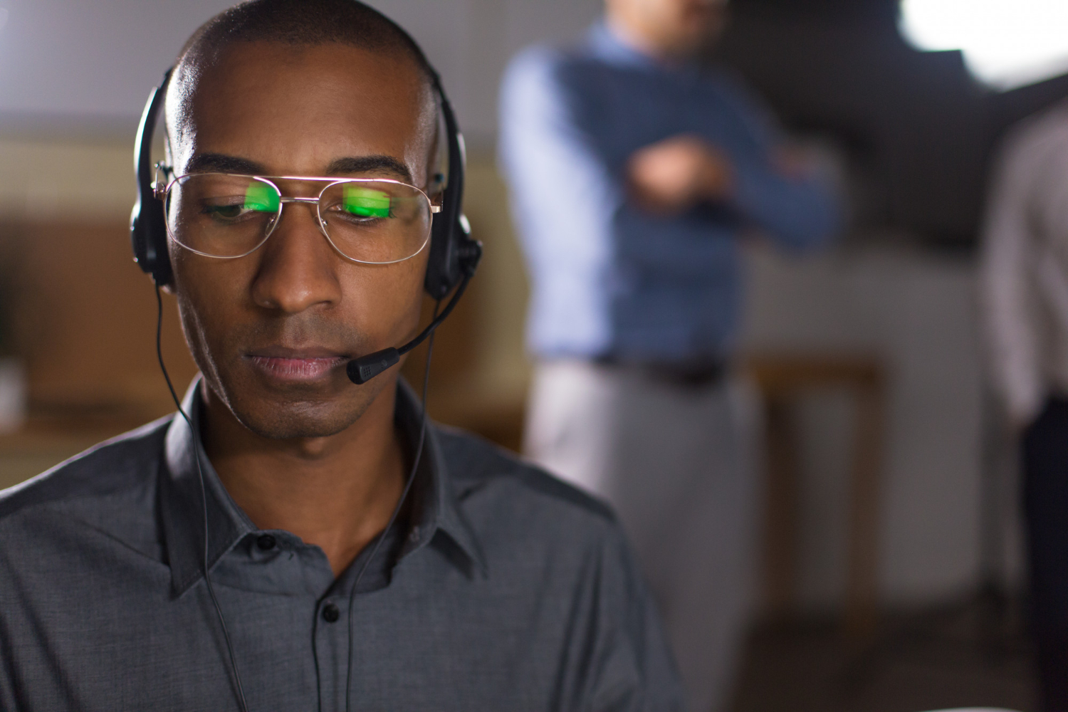 focused-african-american-man-with-headset-looking-down
